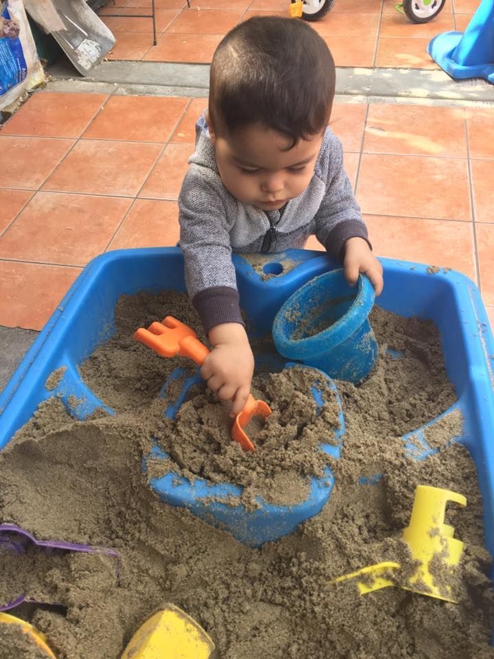 Vicky's Day Care with children playing in the sand box.