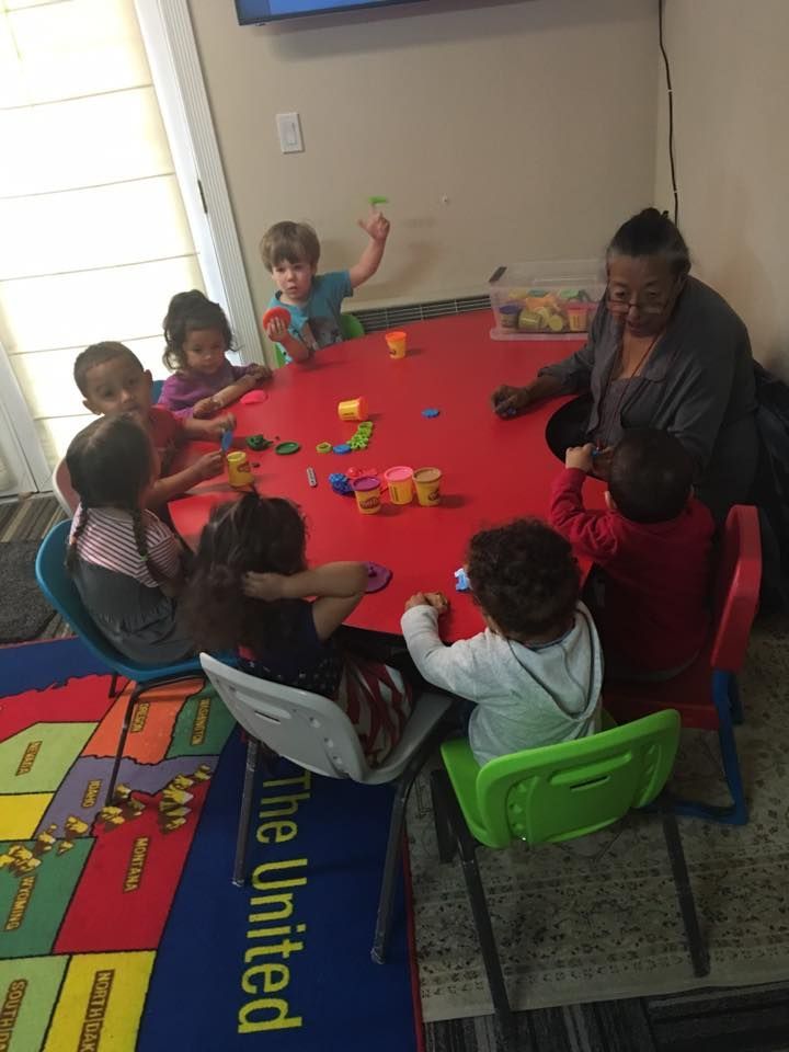 Vicky's Day Care with children doing clay molds.