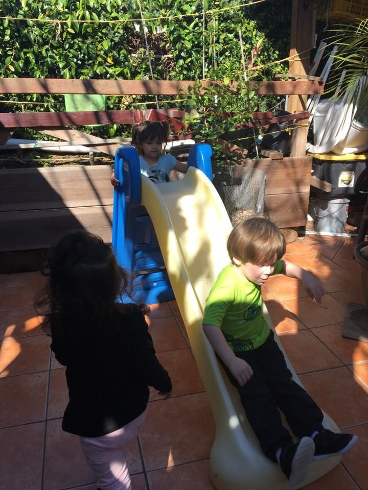Vicky's Day Care with children playing on the slide.