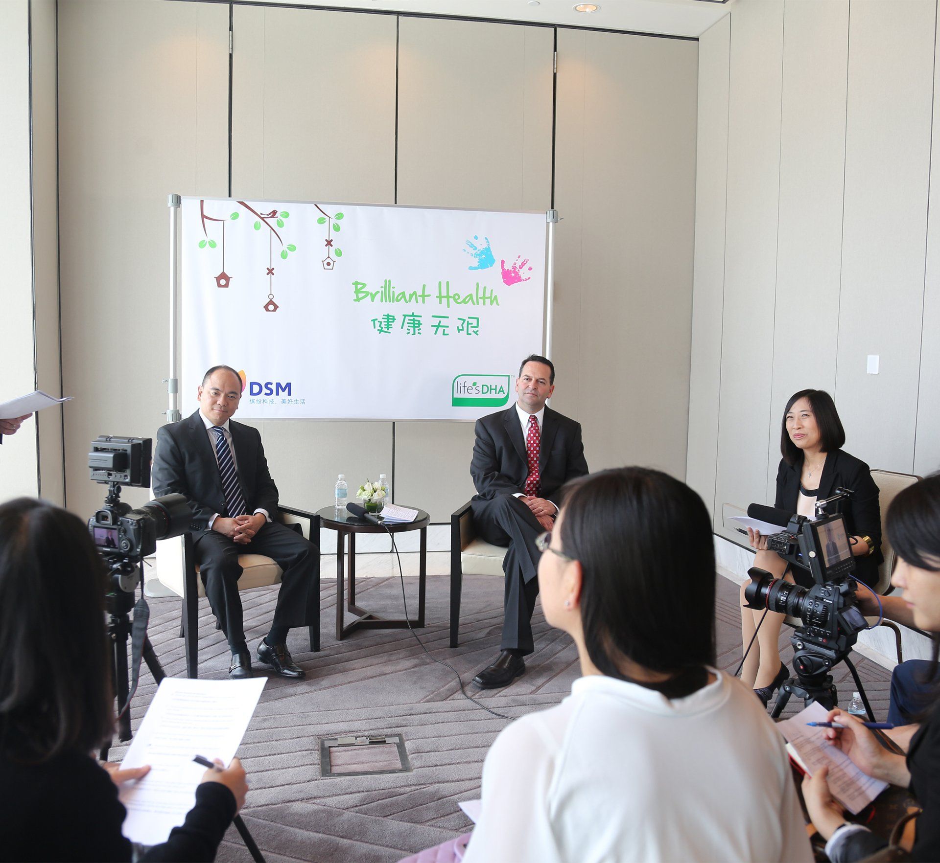 A group of people sitting in front of a white board that says gzm