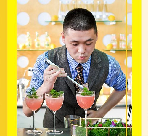 A man in a suit and tie is preparing a drink