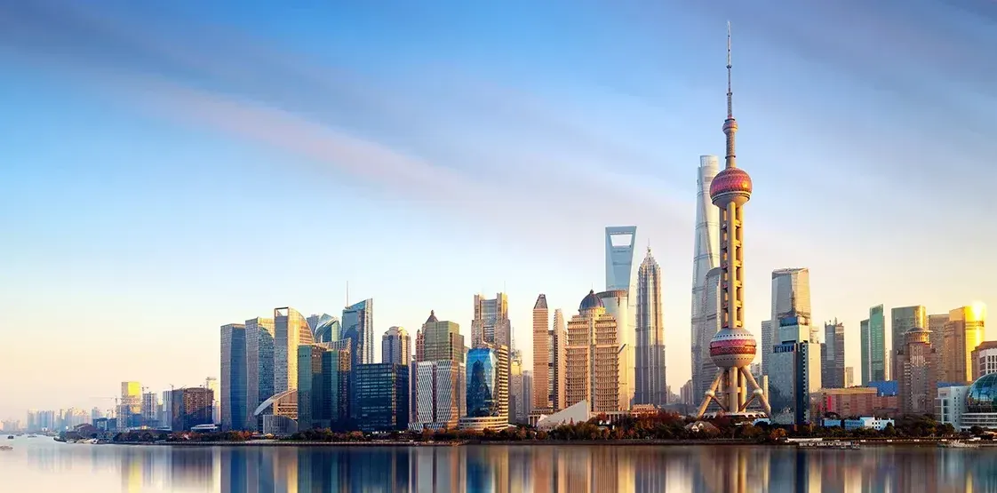 The skyline of shanghai is reflected in the water.