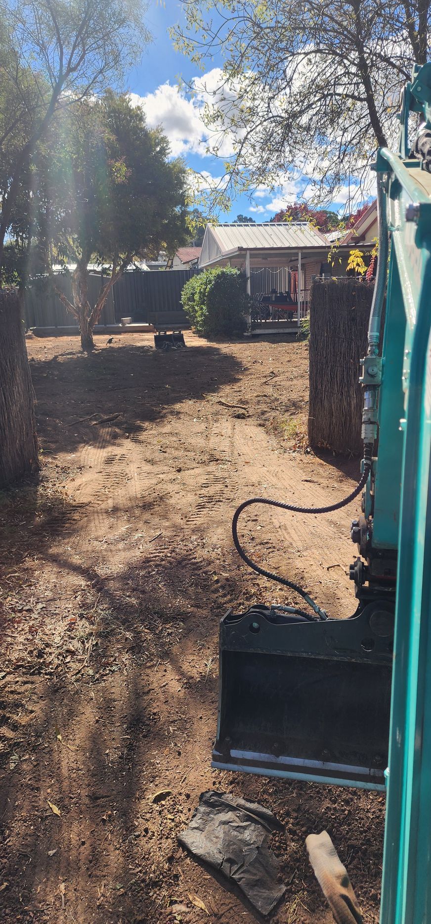 A White Fence with A Tree in Front of It  — GnB Fencing and Excavation in Queanbeyan, NSW