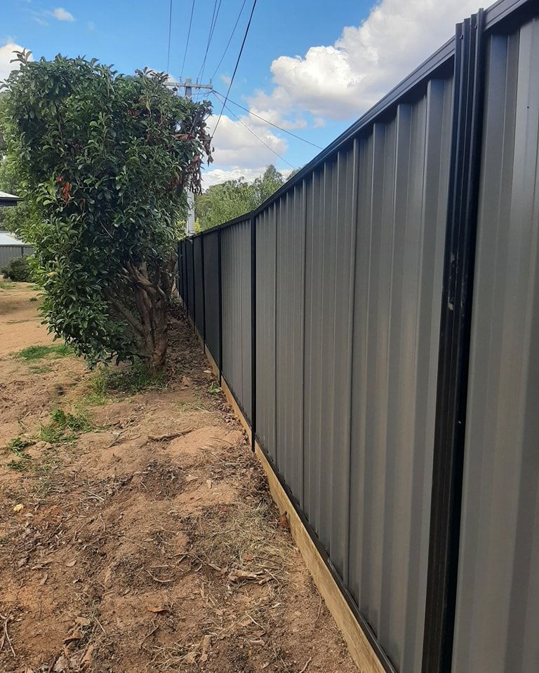 A Fence with A Tree in The Background and A Blue Sky in The Background  — GnB Fencing and Excavation in Queanbeyan, NSW