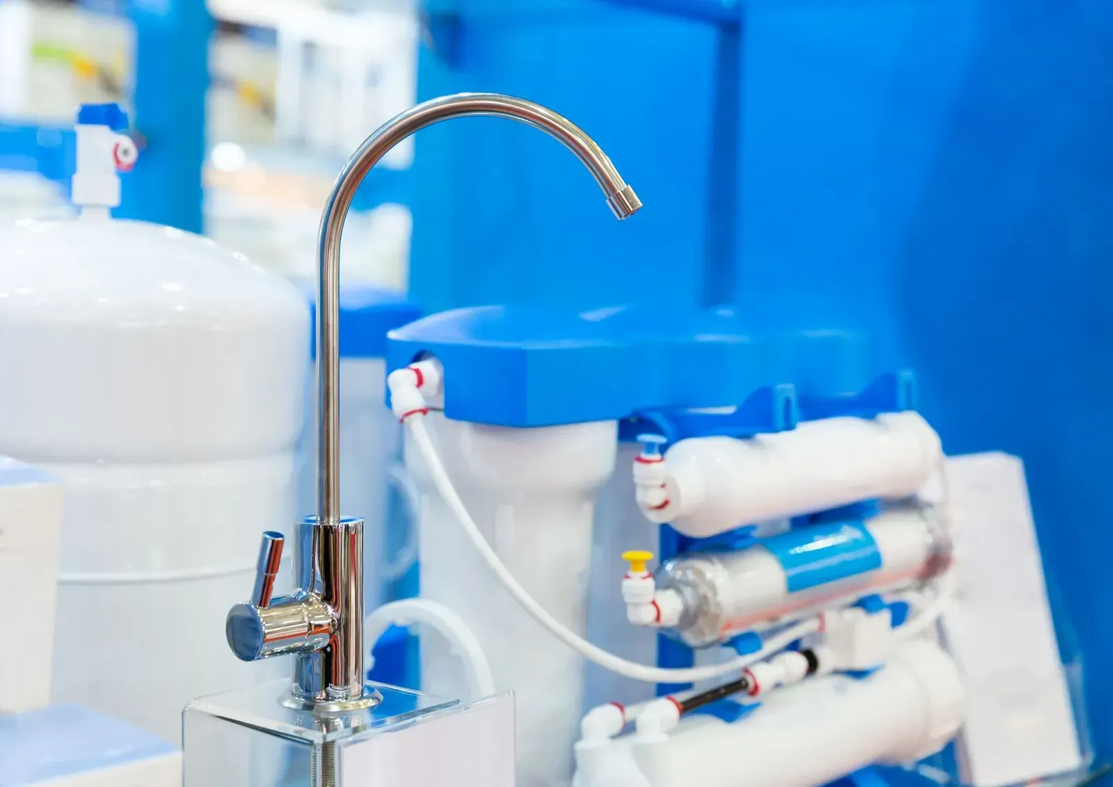 A close up of a water filter with a faucet attached to it.