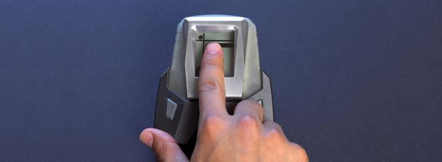 A person is touching a fingerprint scanner with their finger.