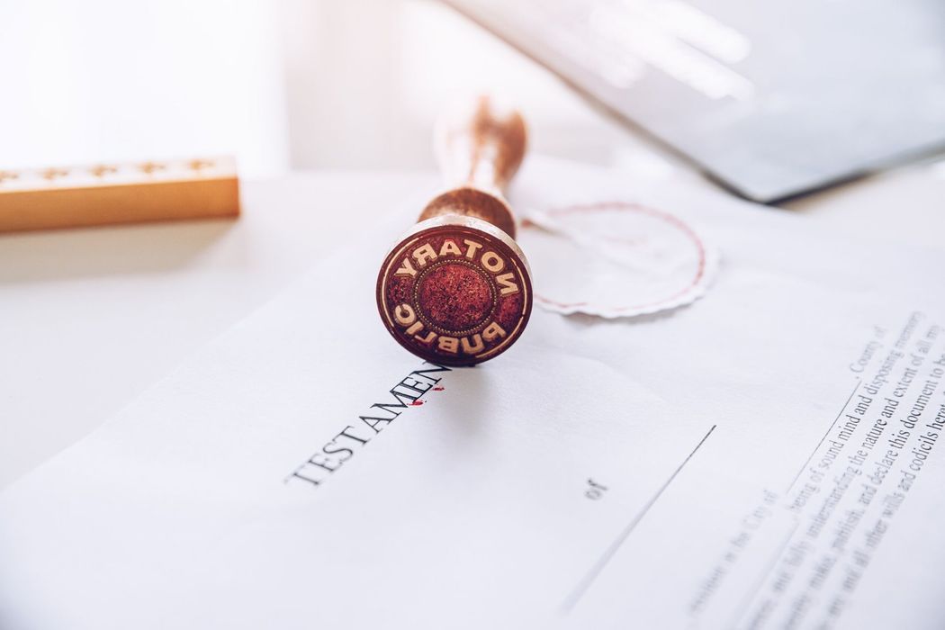 A stamp is sitting on top of a testamentary document.