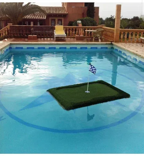 A swimming pool with a putting green in the middle