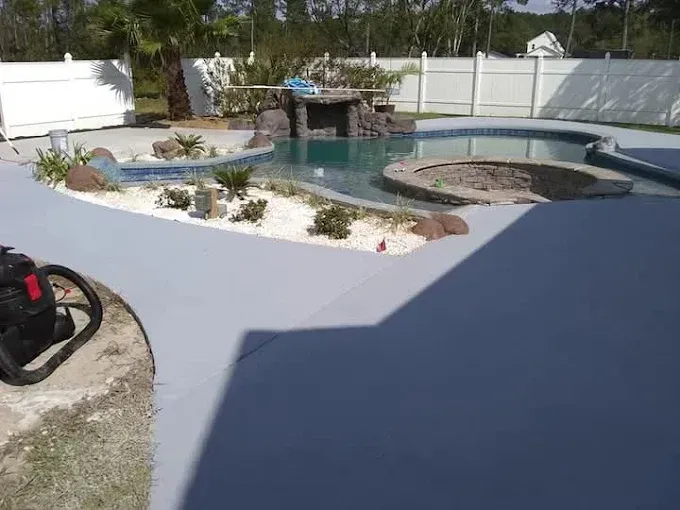 A vacuum cleaner is sitting next to a swimming pool