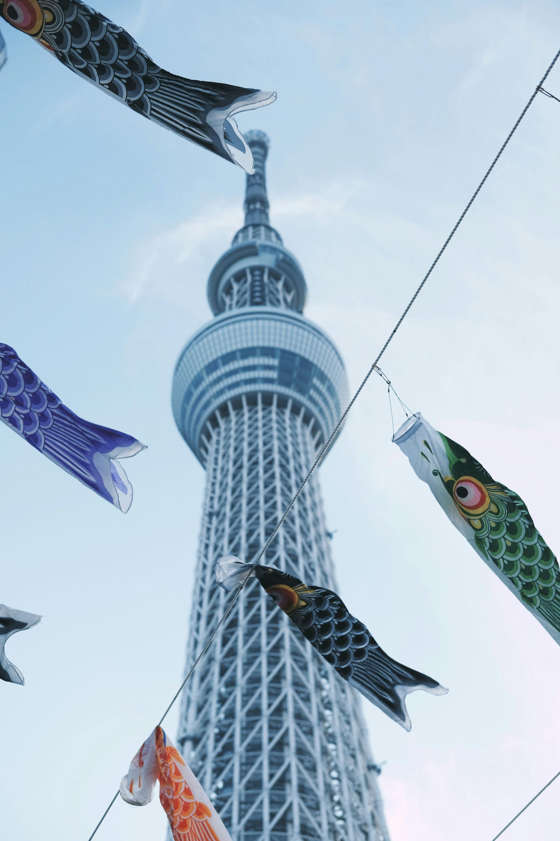 Una torre con un montón de peces volando delante de ella. peces tipicos japoneses de colores