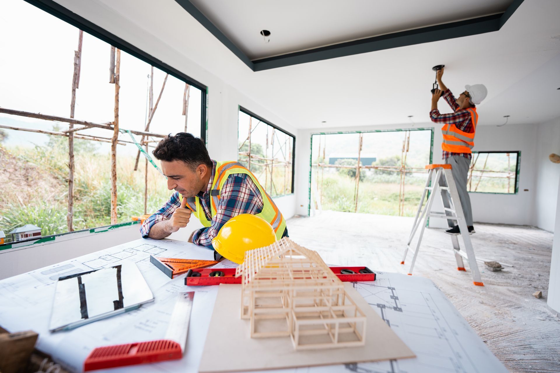 Construction Workers Working on a House Under Construction