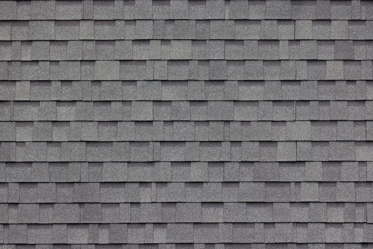 A professional roofer inspecting a roof, showcasing quality craftsmanship and trusted service.