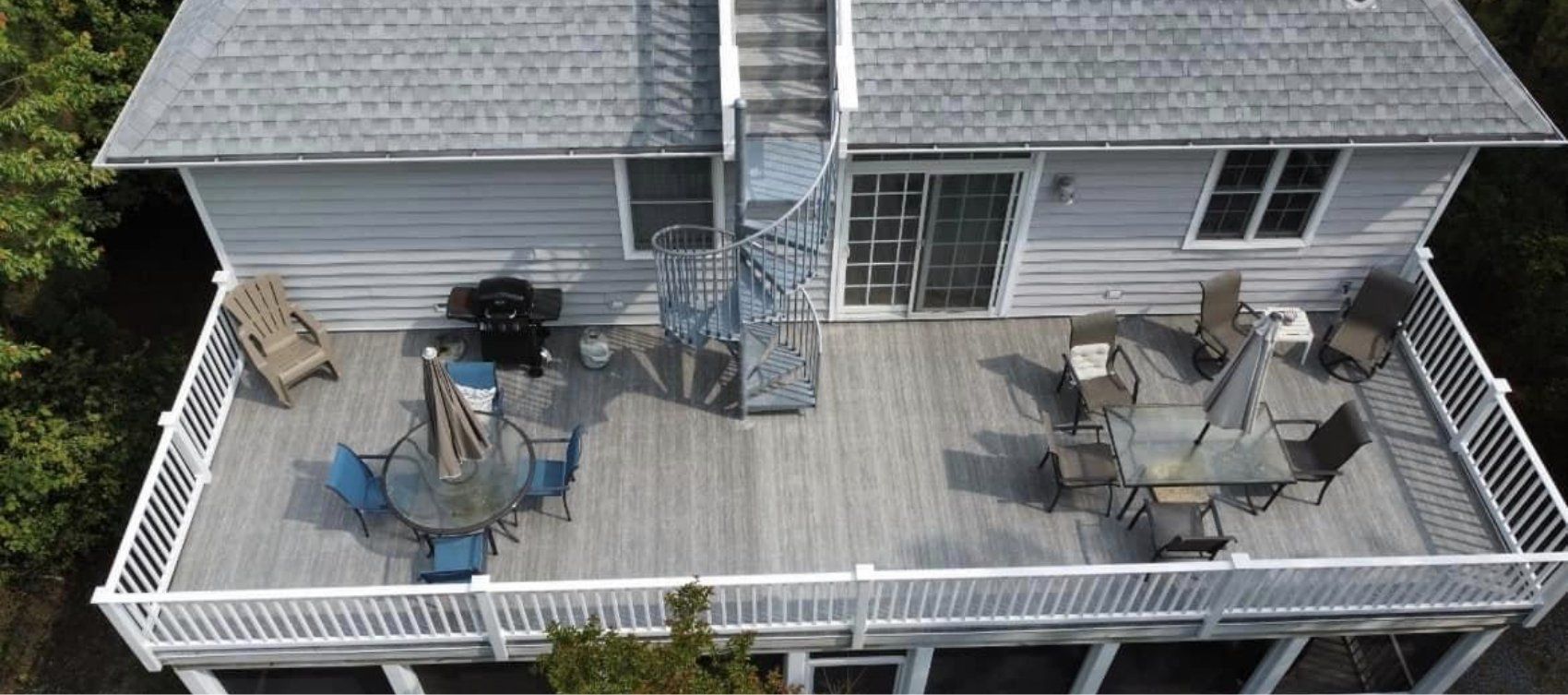 An aerial view of a house with a large deck.