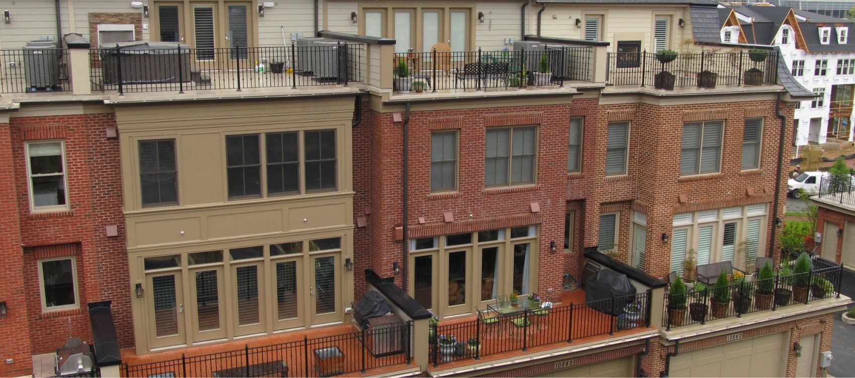 An aerial view of a row of brick buildings with balconies.