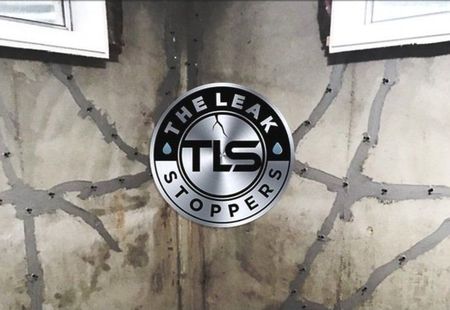 The leak stoppers logo is on a cracked wall