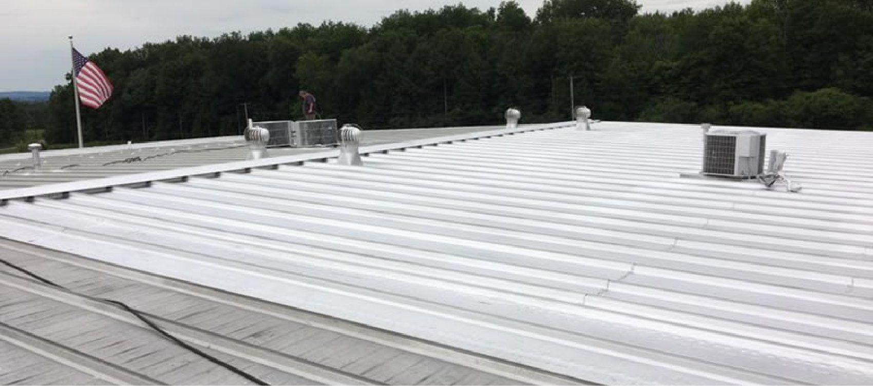 A white roof with an american flag on top of it.