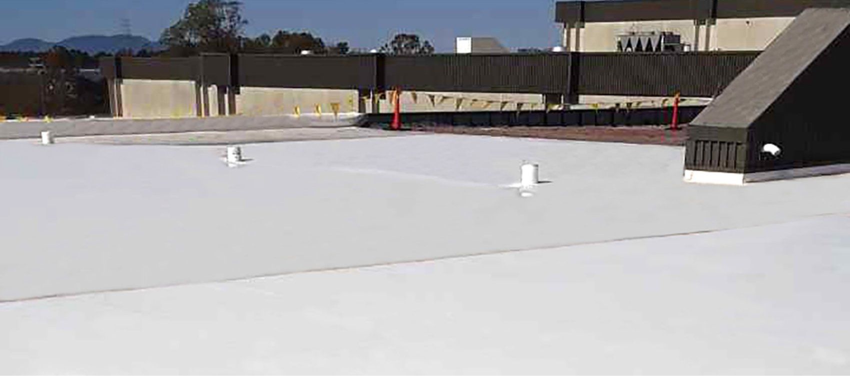 The roof of a building with a white roof is covered in snow.