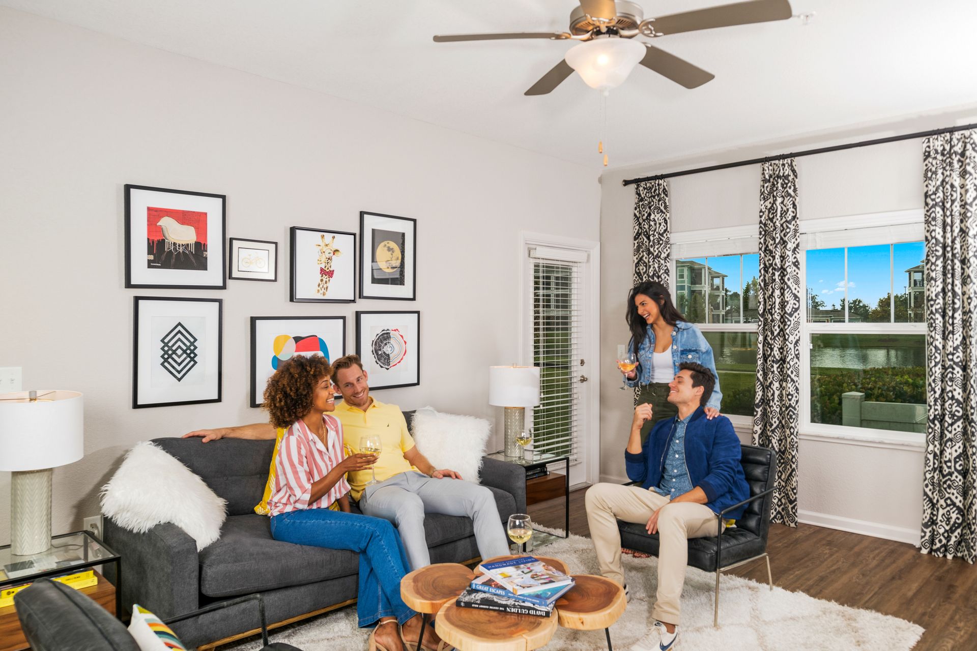 A group of people are sitting on a couch in a living room.