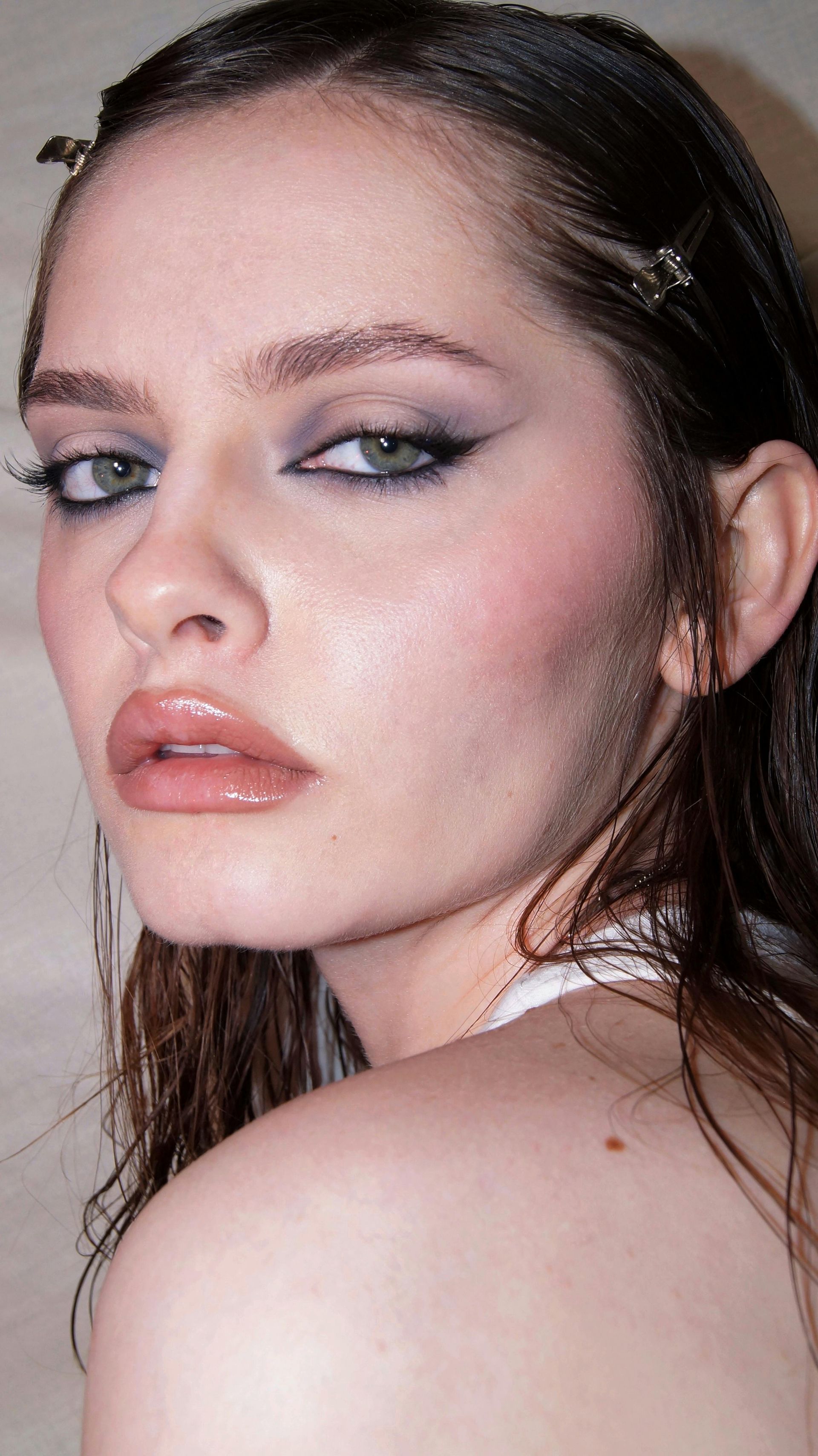 A close up of a woman 's face with makeup on.