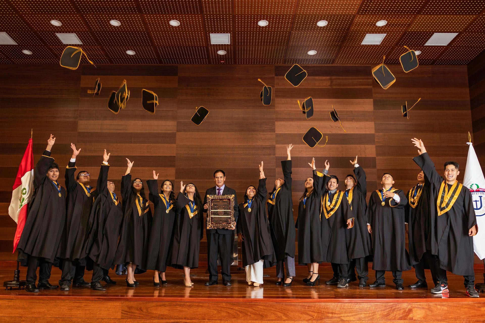 A group of graduates are throwing their caps in the air.