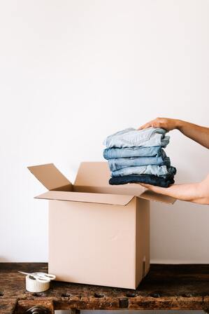 packing clothes in a box