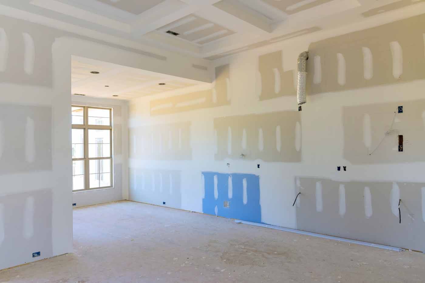 An empty room with a lot of drywall on the walls.
