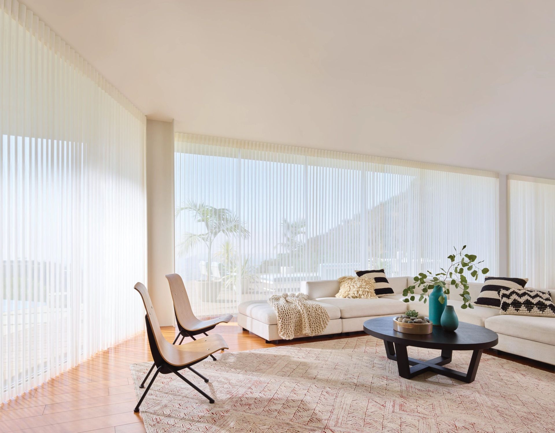 A living room with a couch , chairs , and a coffee table.