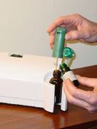 A person is pouring essential oils into a machine.