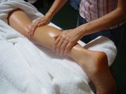 A woman is getting a massage on her leg.