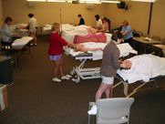 A group of people are giving massages to each other in a room.