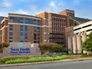 A large brick building with a sign in front of it.