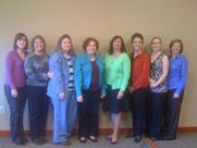 A group of women are posing for a picture together.