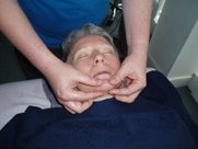 A woman is getting a massage on her face.