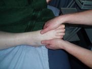 A person is giving a foot massage to another person.