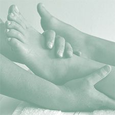 A person is giving a foot massage to another person.