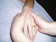 A person is giving a woman a massage on her wrist.