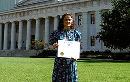 Mari S. Truman holding her certificate.