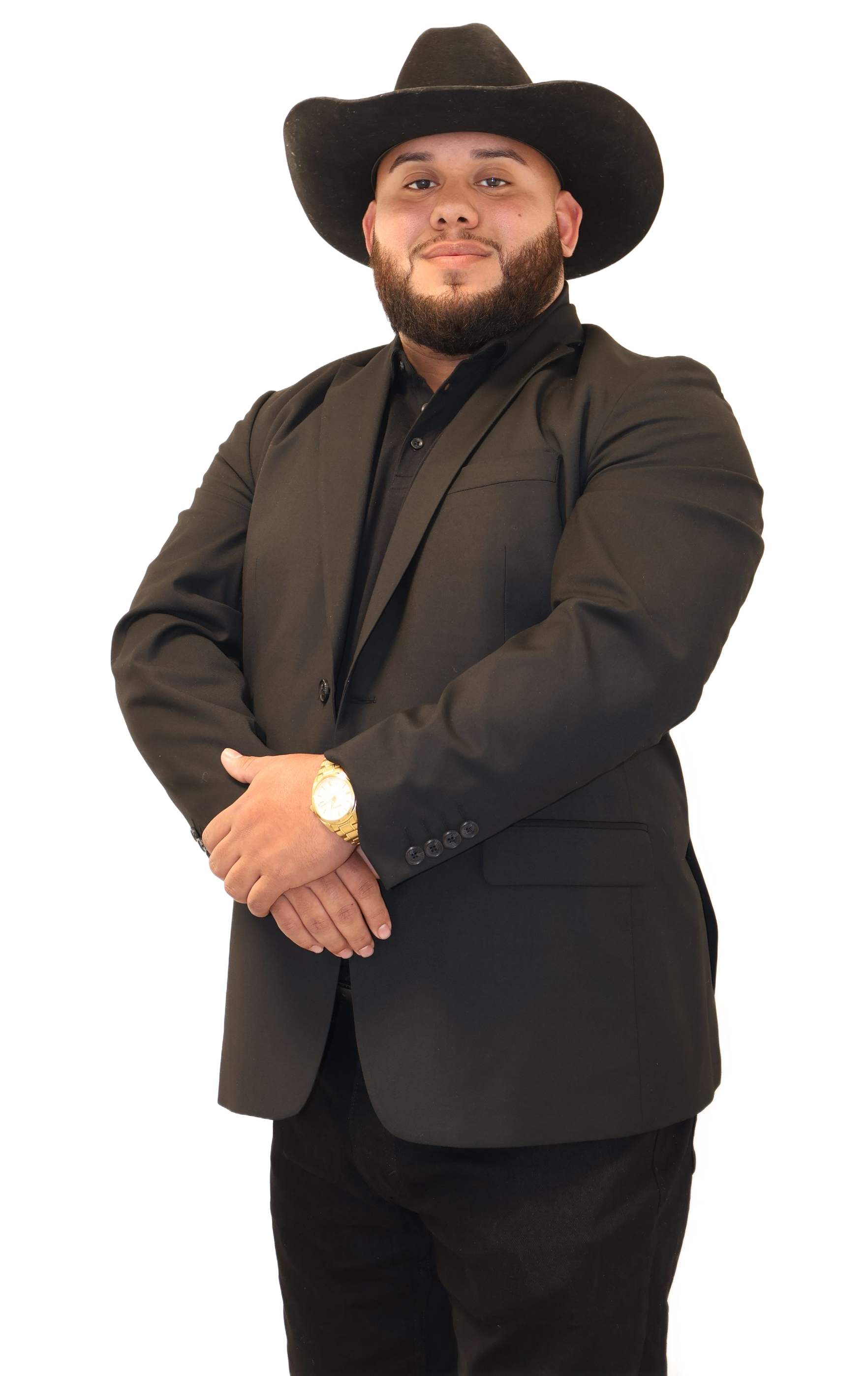Man in black cowboy hat, blazer, and dark shirt, arms crossed, smiling.