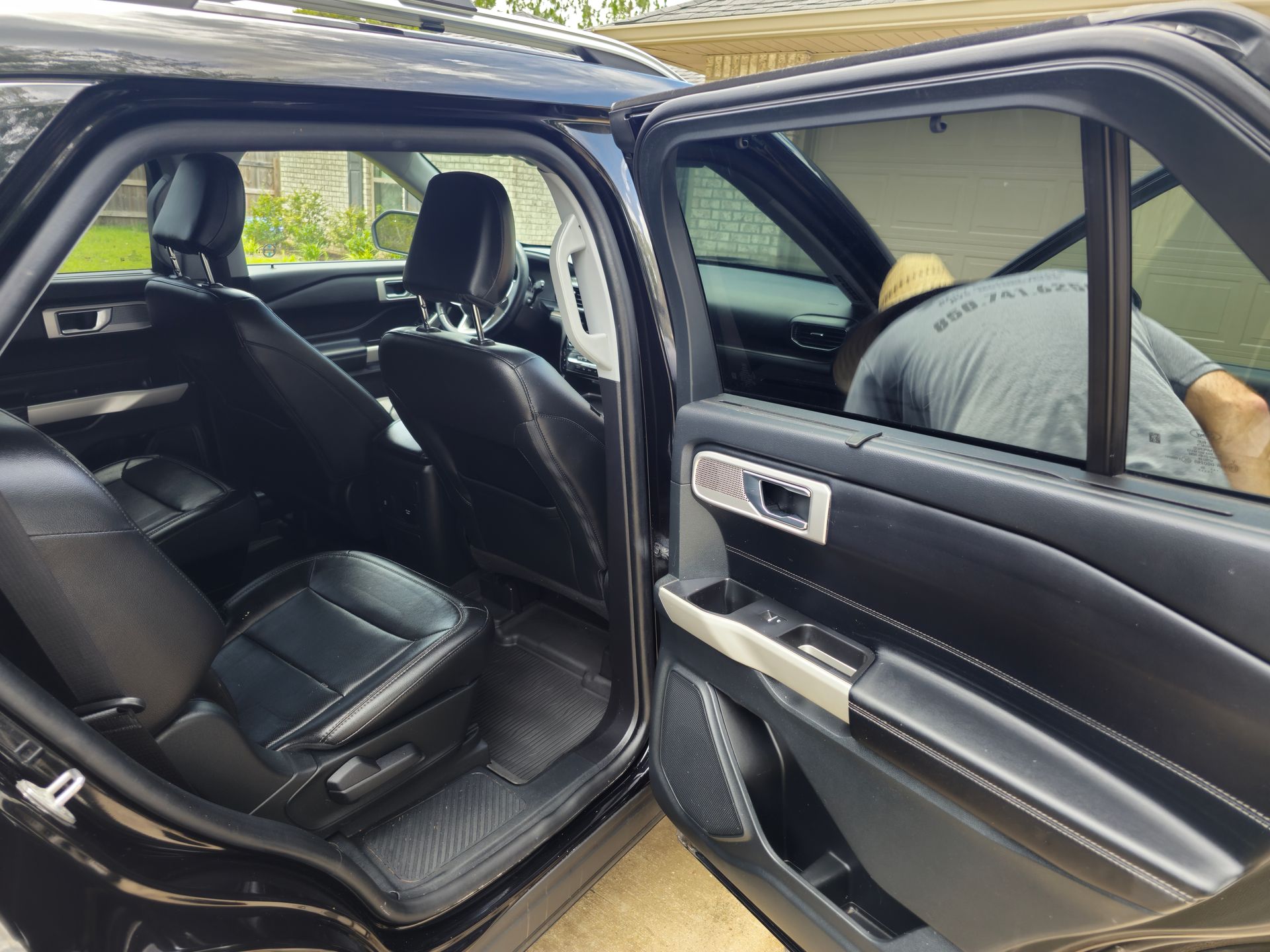 The inside of a black car with the door open