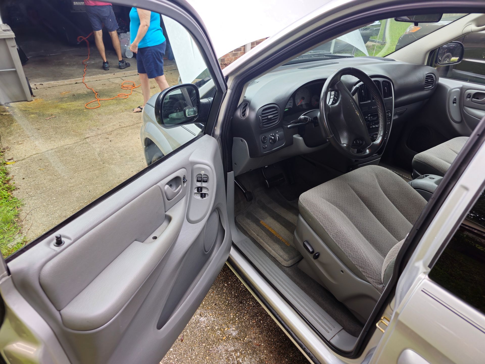 The inside of a silver car with the door open