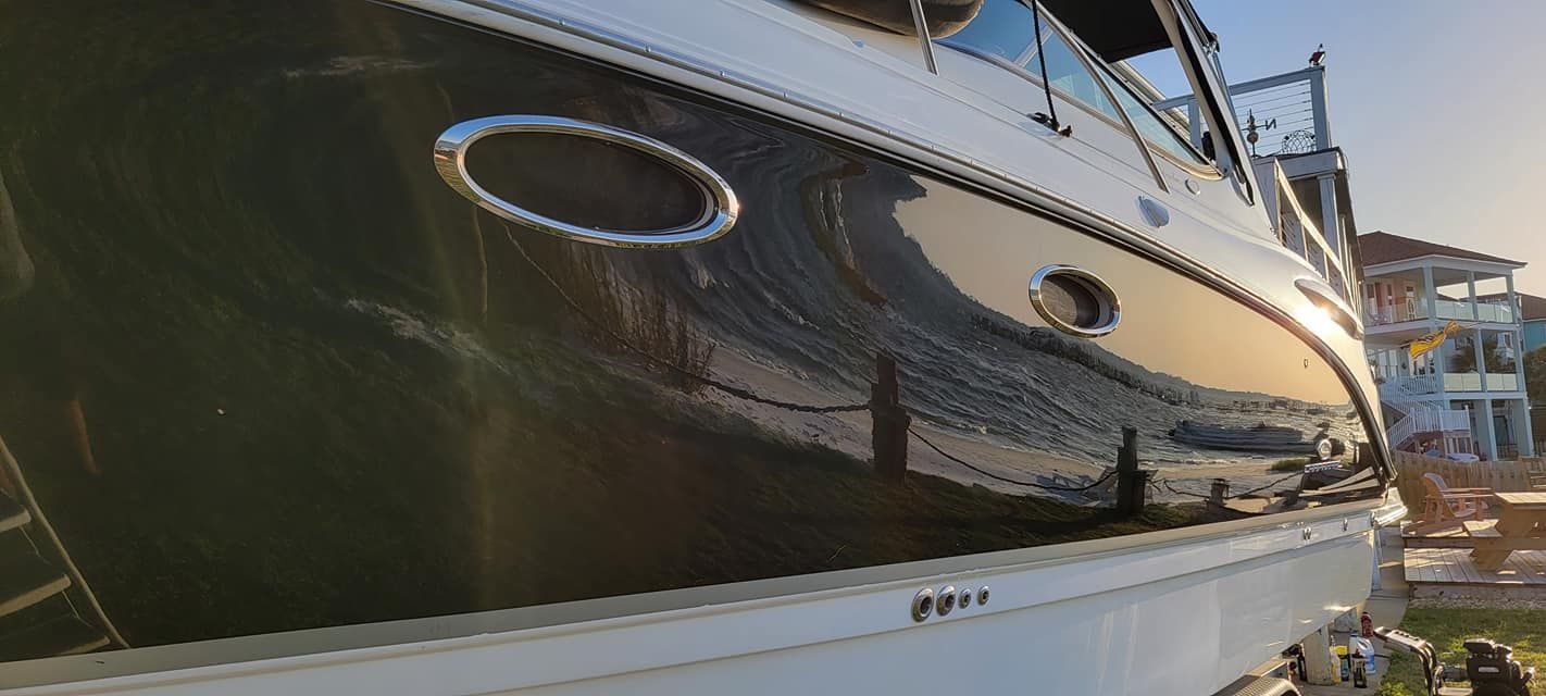 A black and white boat is docked in a marina.