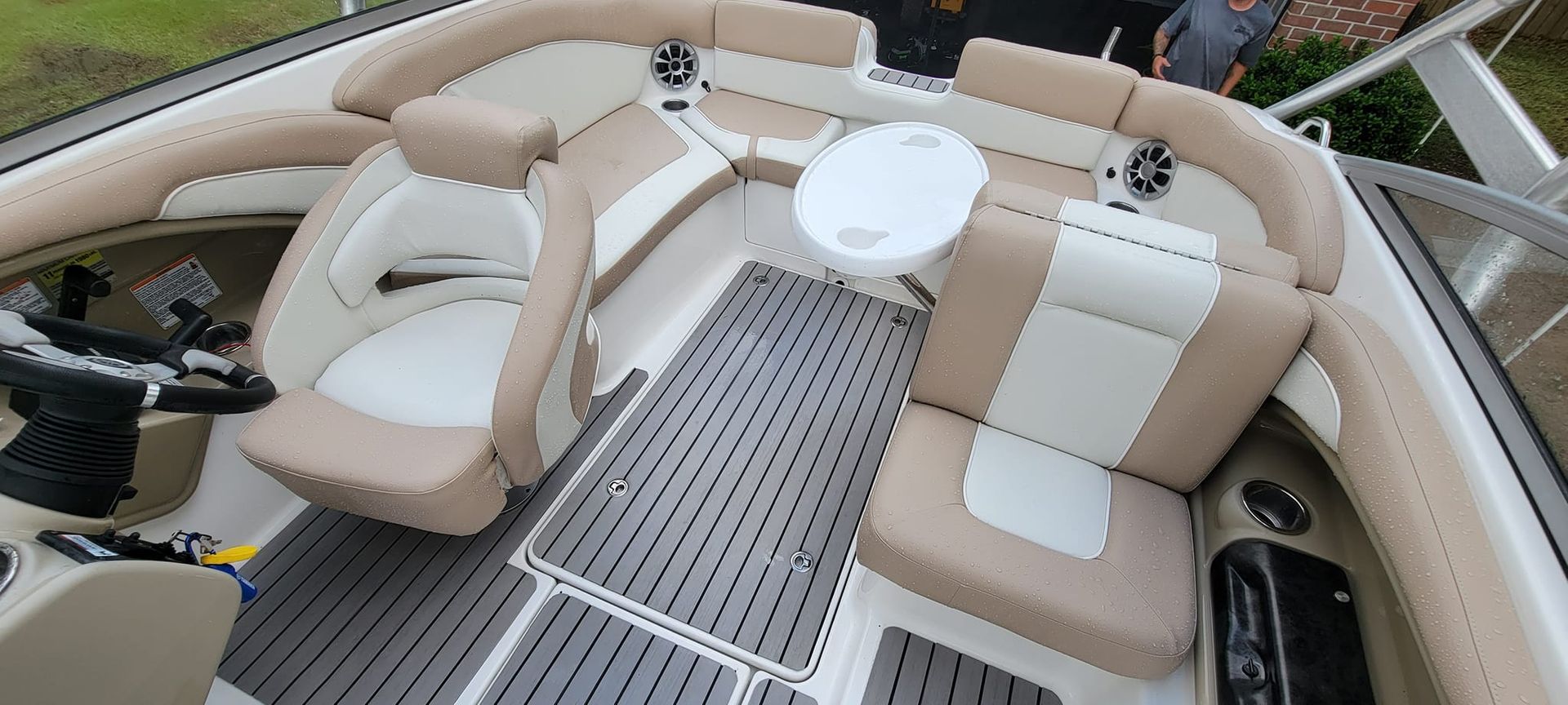 The inside of a boat with a table and chairs.