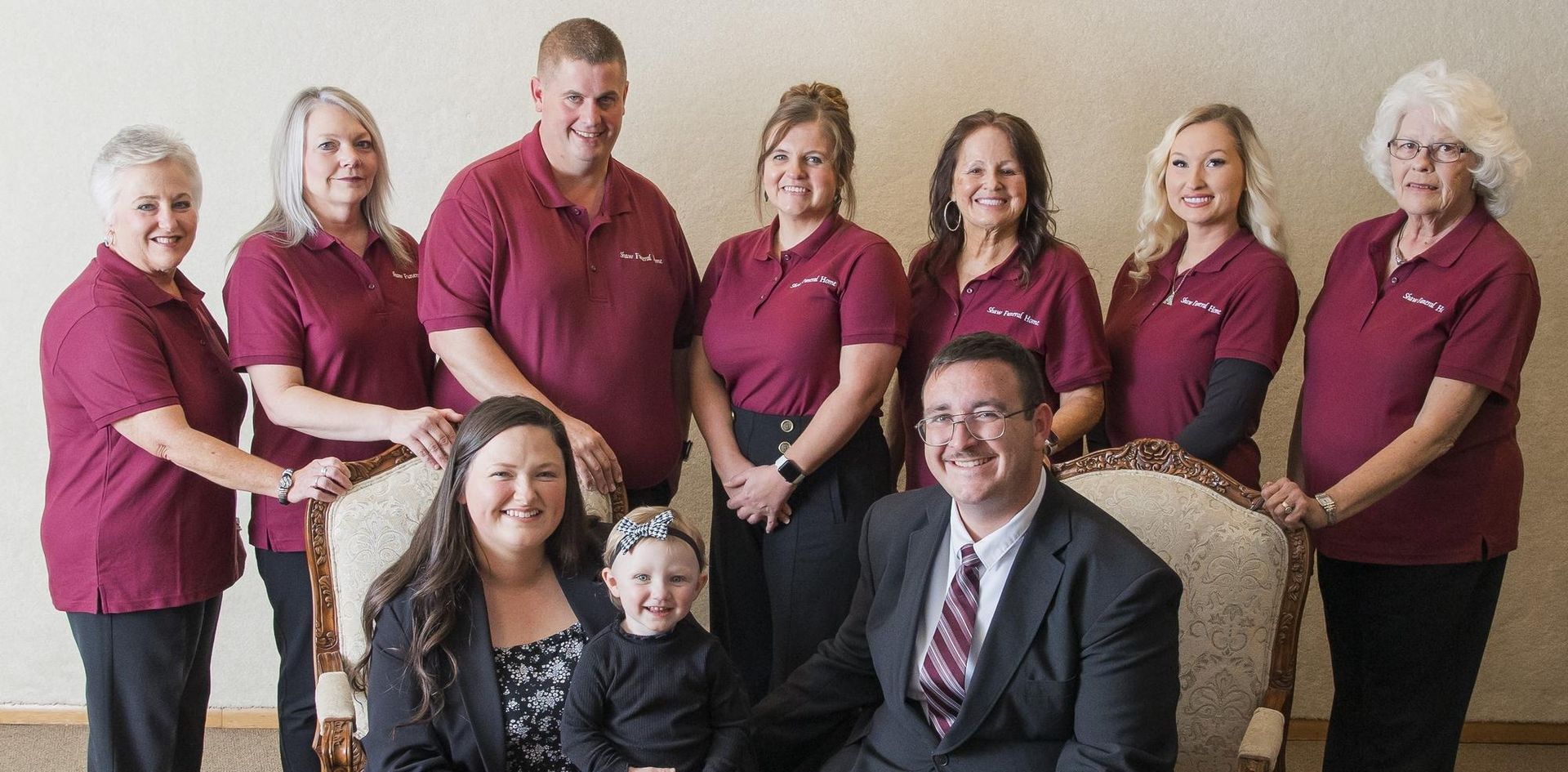 The front door of a house with a porch and plants in front of it.