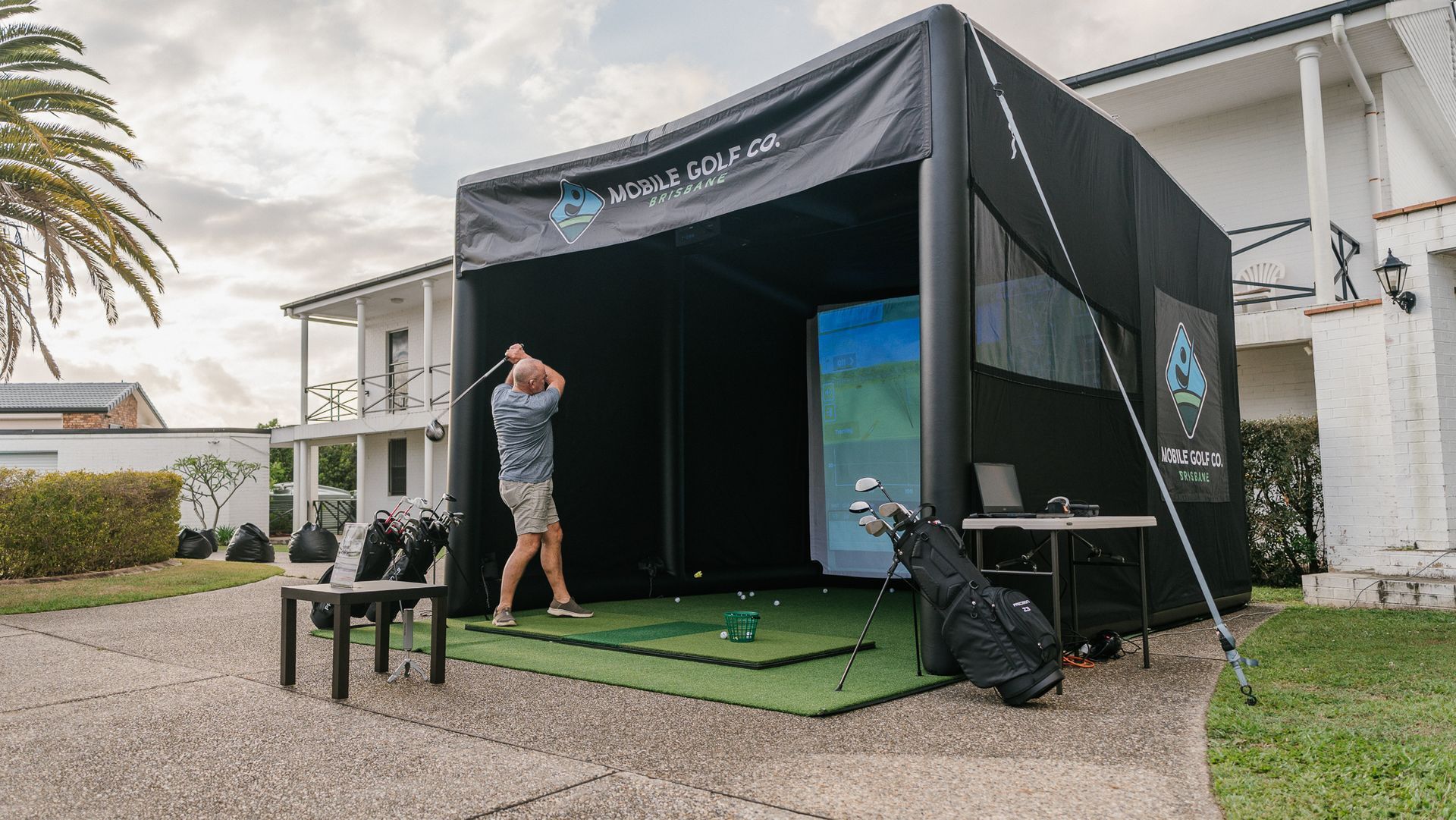 golfer has hit a ball with his driver on the fairway, clear blue sky.