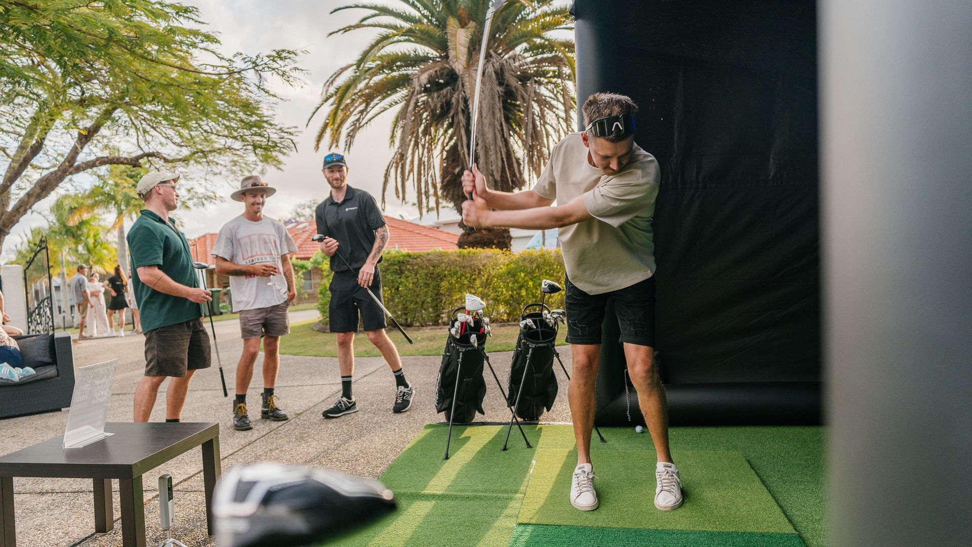 titleist golf ball resting next to flag in the hole