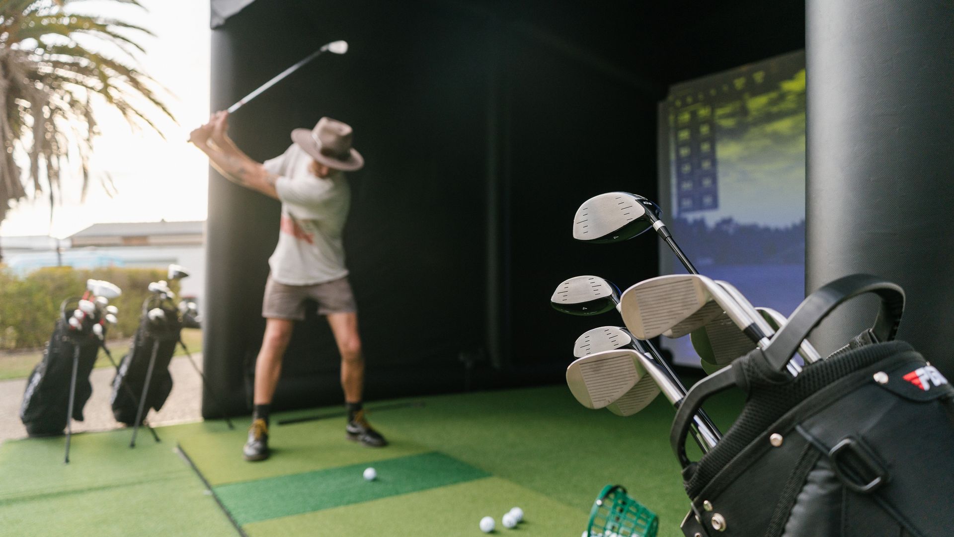 golfer has just hit the golf ball with his driver down the fairway, clear blue sky.