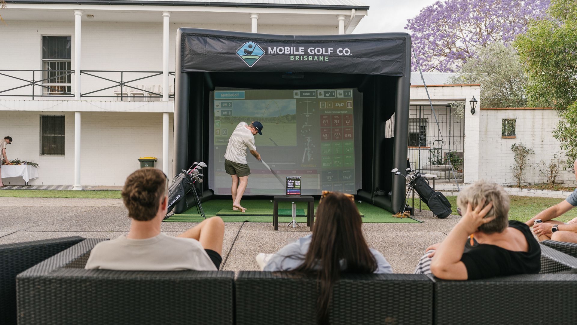a christmas bauble rolling into the hole on a golf putting green.