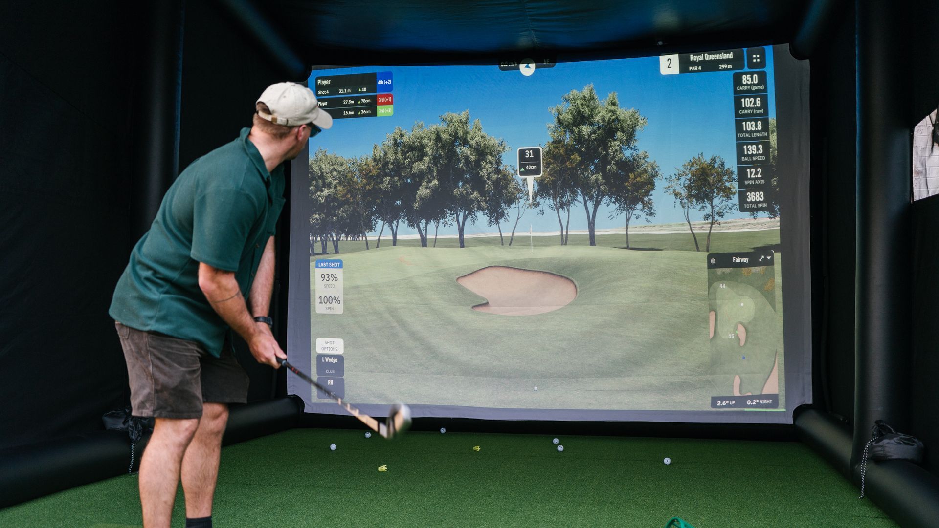 A golfer thinking about his wedge shot over the bunker and onto the green.