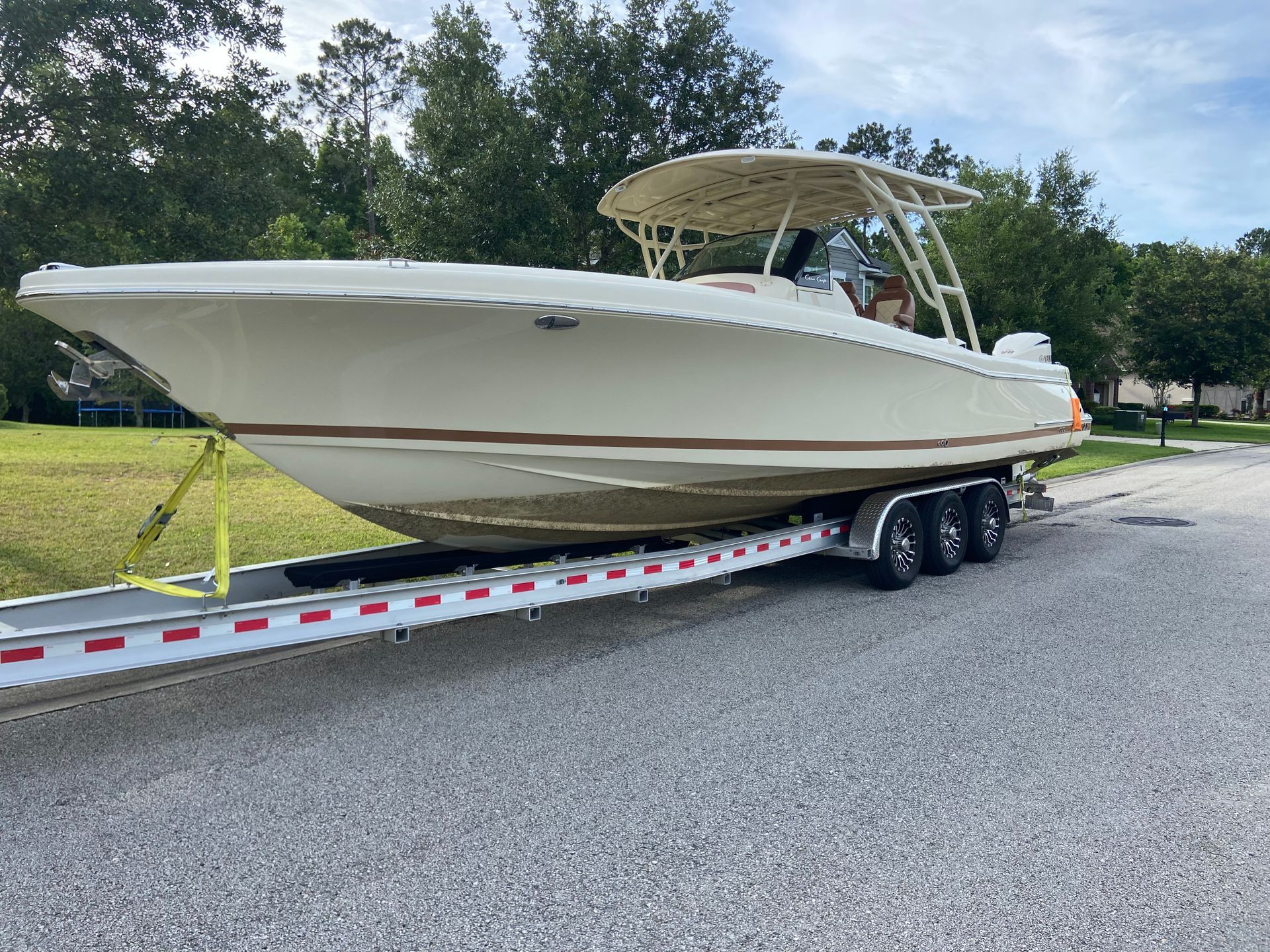 A white boat is sitting on top of a trailer.