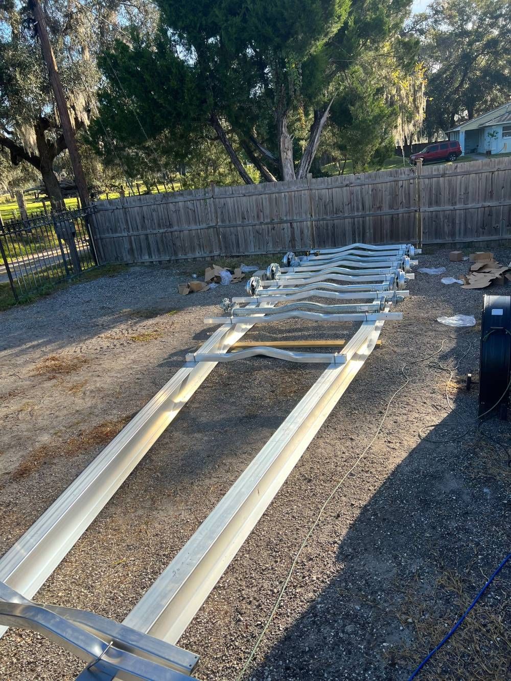 A row of metal rails sitting on top of a gravel road.